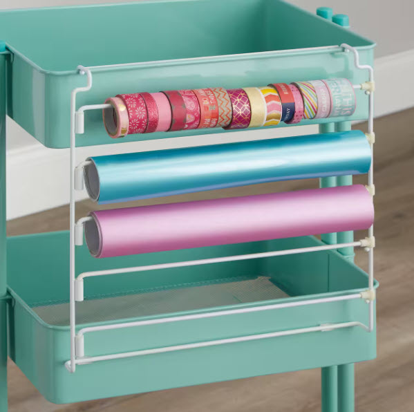 Teal rolling cart with a white storage hanger on the side with rolls of washi tape and vinyl rolls stored on it