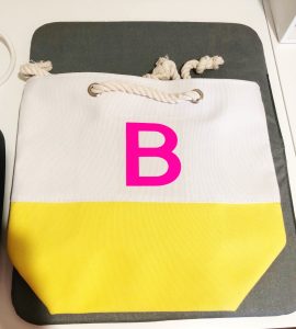 Placement of the prepared Cricut Iron-On Monogram on the Tote Bag