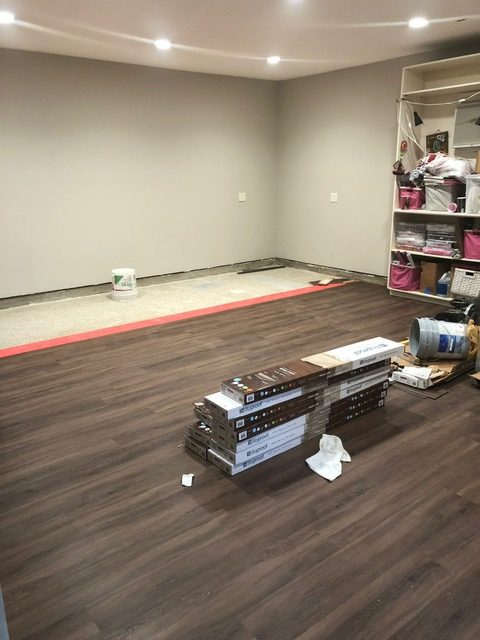 vinyl plank flooring being installed in room