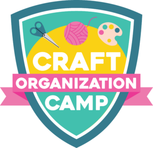shield looking logo with craft organization camp